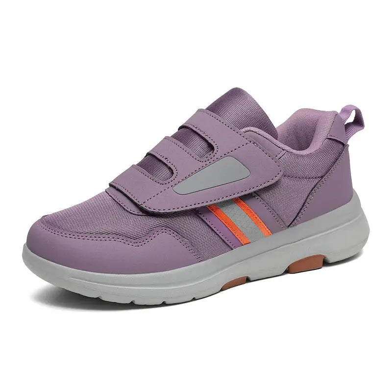 Wide Toe Sneakers in lavender with dual Velcro straps and orange side accents; cushioned sole.