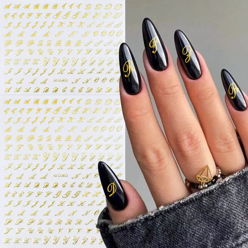 Simples Market 3D Roman Letter Nail Stickers in gold; black nails shown with gold initials