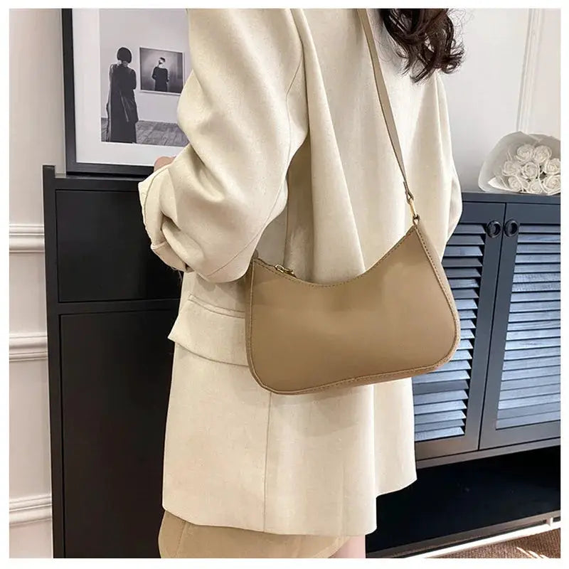 Tan solid-color handbag with a single shoulder strap; small square-style bag
