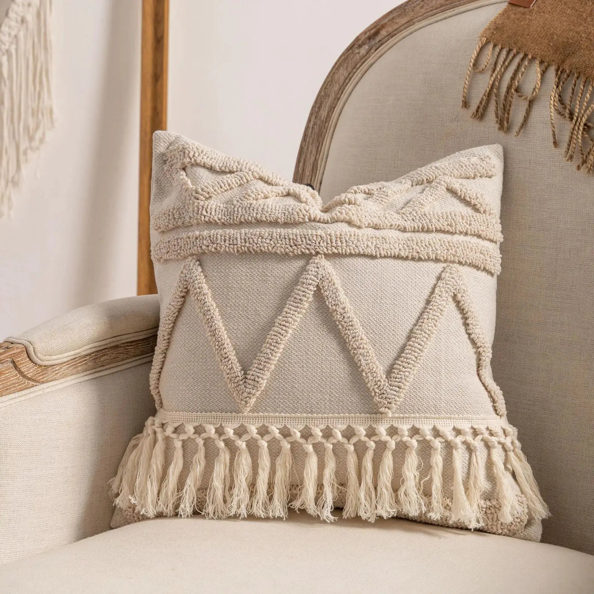 Two beige woven pillow covers with chunky fringe tassels for boho sofa decor