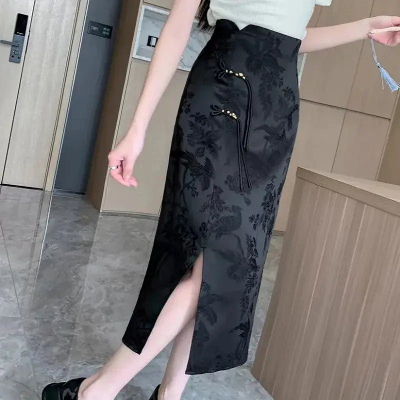 Chinese-style black floral high-waist midi skirt with front slit and gold-tone tassel zipper accents