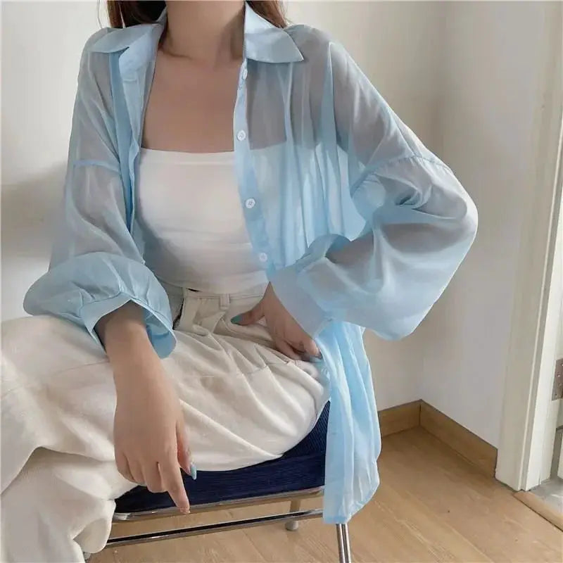 Chiffon blouse; light blue sheer long-sleeve shirt layered over white top, casual loose fit