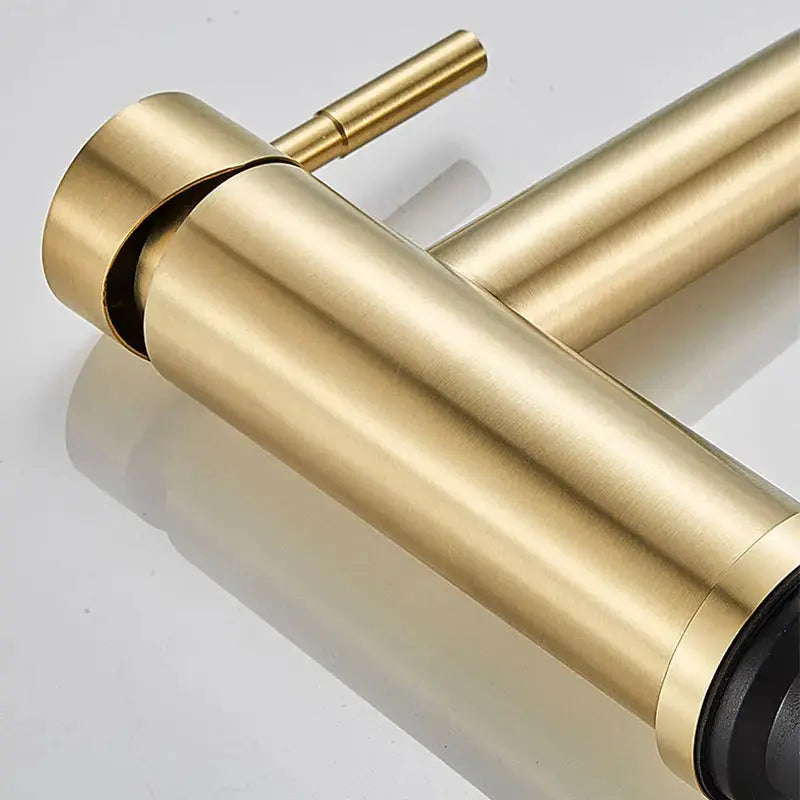 Brushed gold stainless steel bathroom faucet with modern cylindrical deck-mount tap and lever for hot/cold control