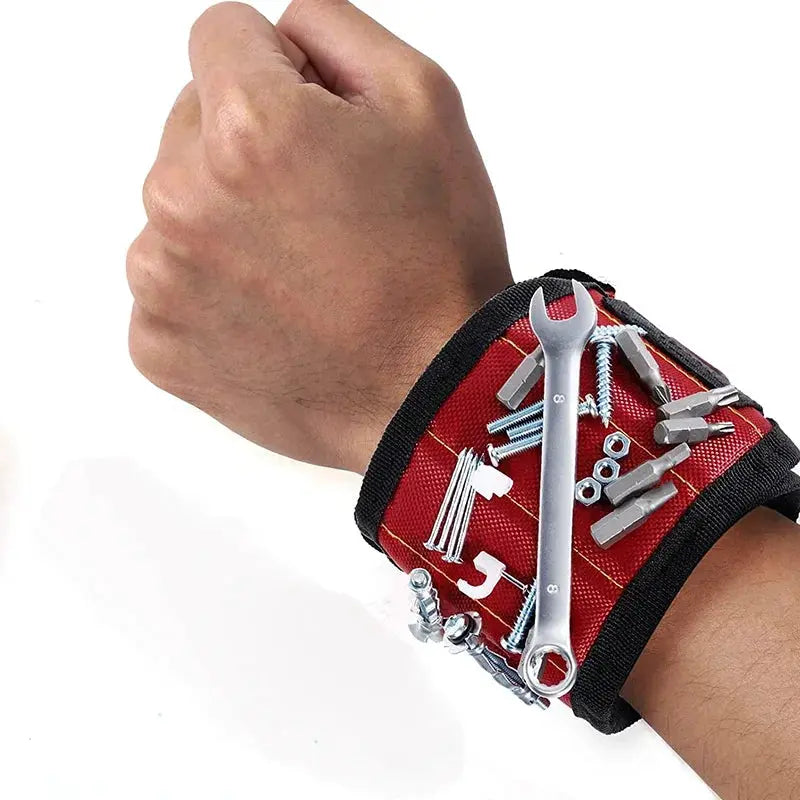 Magnetic tool wristband in red fabric with nails, screws and a wrench on top