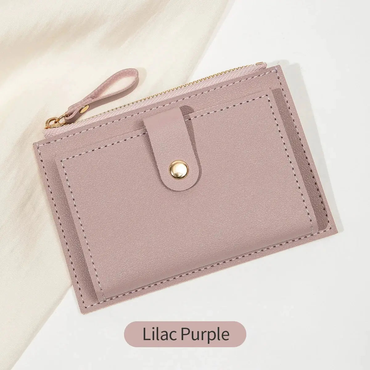 Lilac purple minimalist short card wallet in PU leather with zipper, card slots, and a small strap with a gold snap
