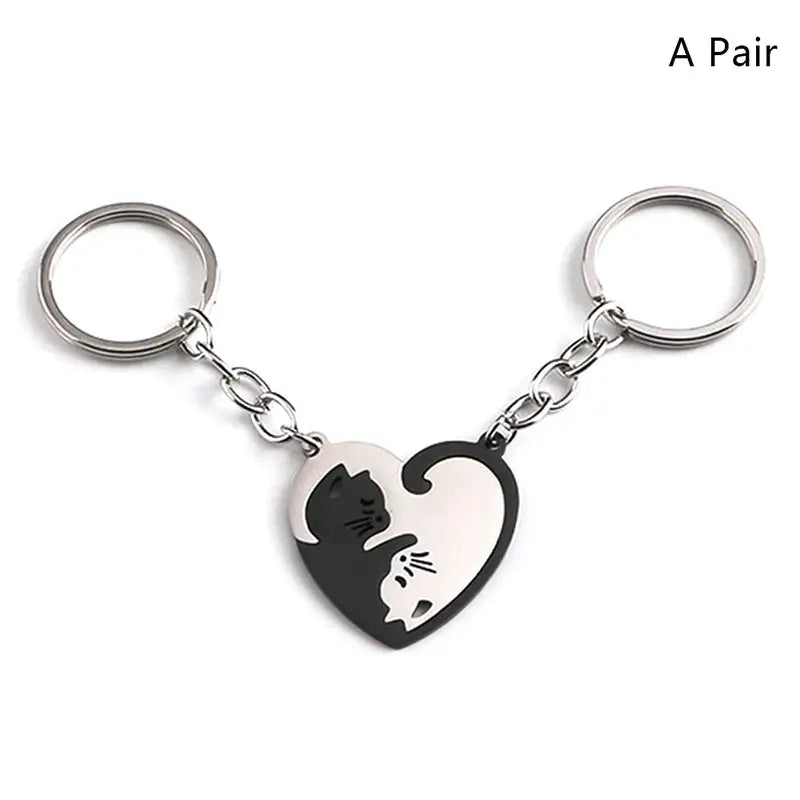 Pair of stainless steel heart keychains featuring black and white cat silhouettes hugging inside a heart.