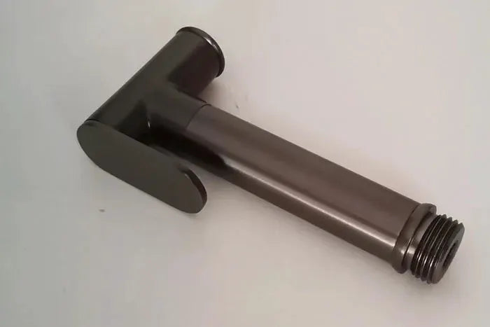Brass handheld bidet shower head in brushed gold and gray with black lever and threaded connector.