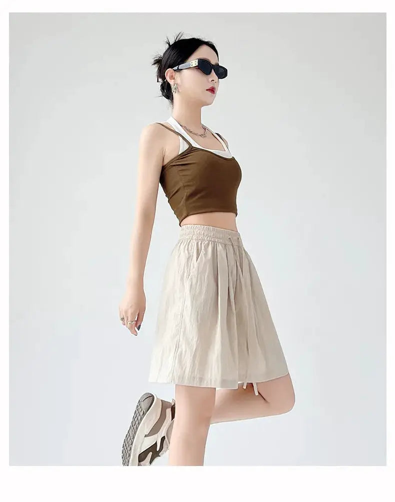 Beige high-waisted women's shorts with elastic waistband and two pockets