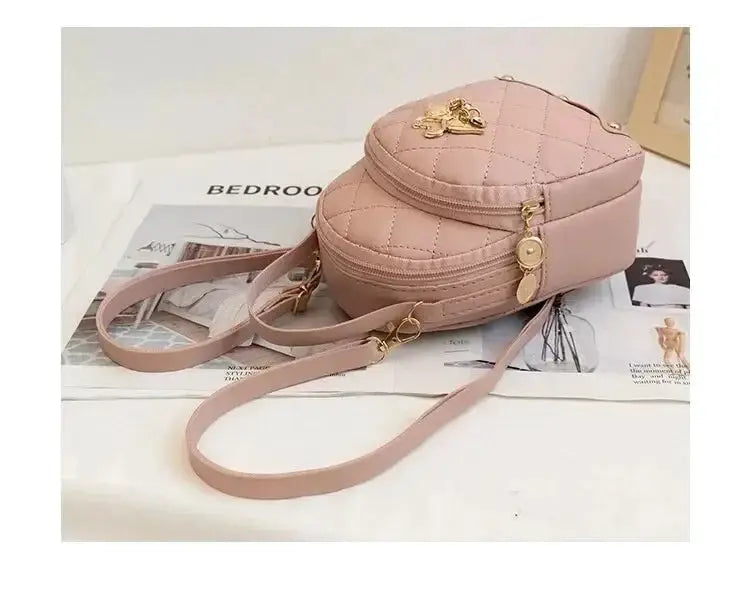 Fashion women's mini backpack in pink quilted style by Simples Market with gold hardware and adjustable strap.