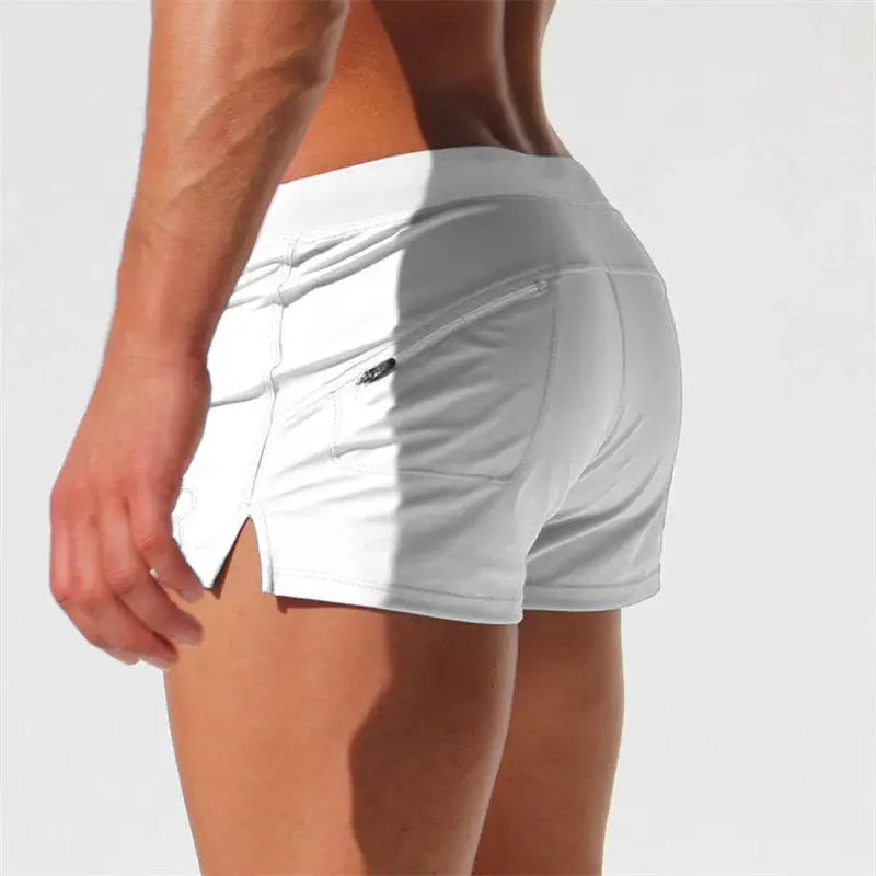 Men's white swim trunks with back pocket detail and side slits, quick-drying fabric