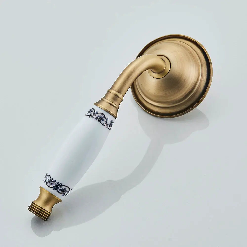 Antique brass handheld shower head with ceramic white handle and blue floral decor, Simples Market