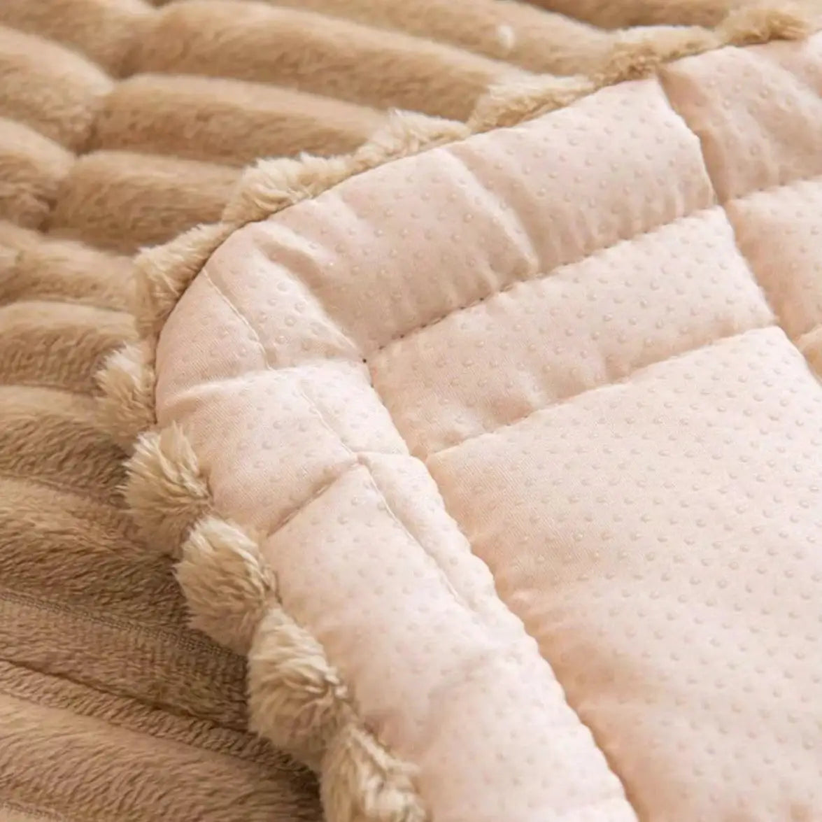 Thick quilted flannel sofa pad in beige with dotted fabric and pom-pom fringe