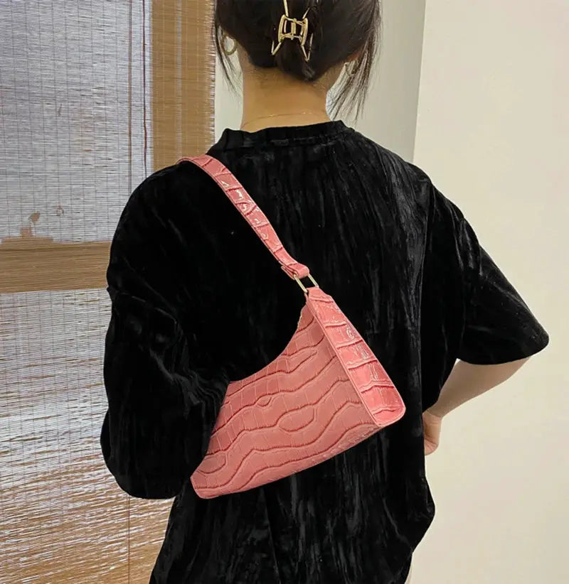 Pink alligator-pattern PU leather underarm handbag with a slim strap