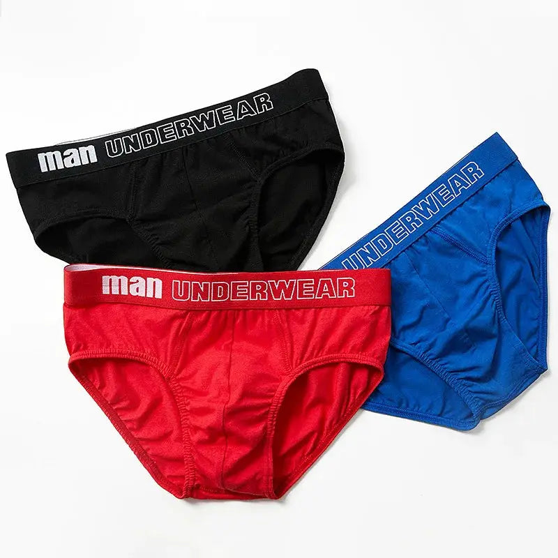 Cotton men's briefs trio in black, red and blue with elastic waistband reading MAN UNDERWEAR