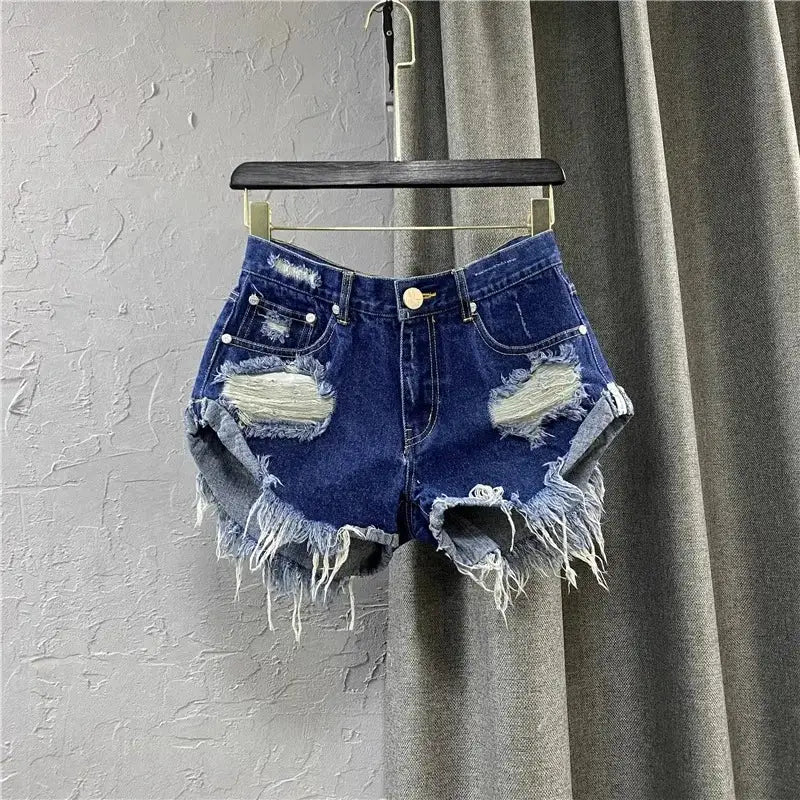 Blue denim distressed shorts with frayed hems and zipper fly by Simples Market