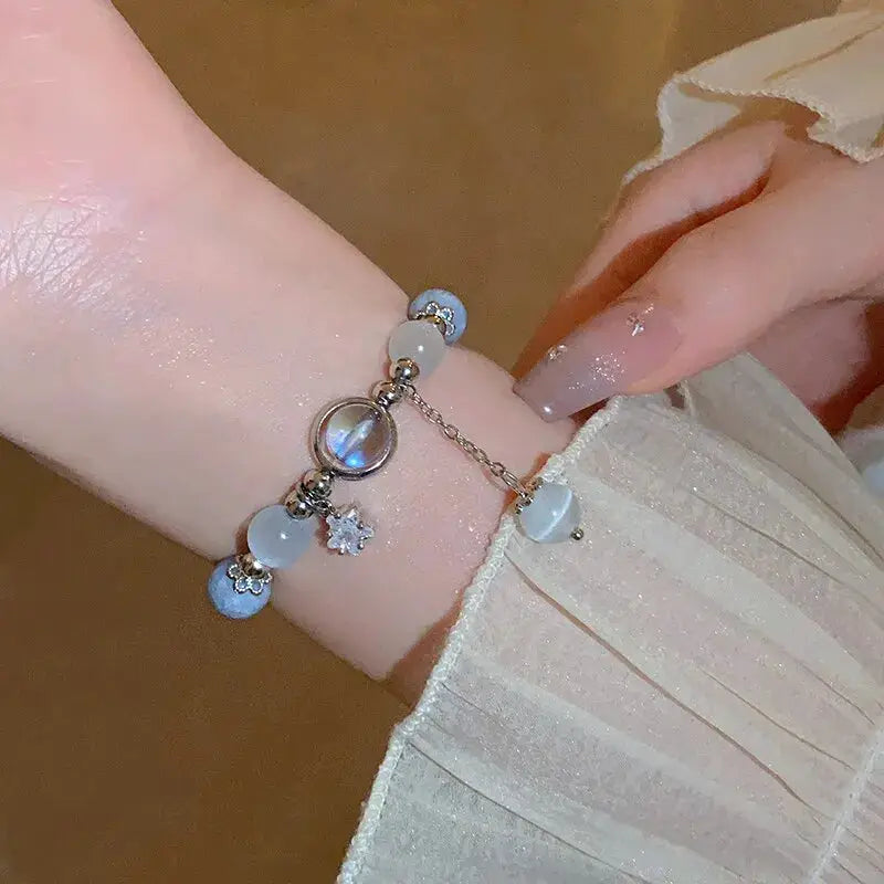Bracelet for women featuring blue opal beads and moon-star crystal charms on a silver chain