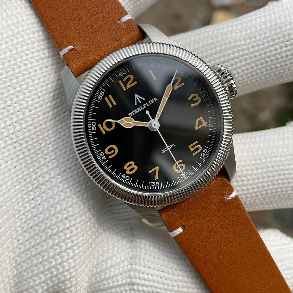 STEELFLIER SF741 wristwatch with black dial, tan leather strap, stainless steel case.