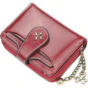 Women's retro red leather mini wallet with zip closure, double-fold design and clover charm chain.