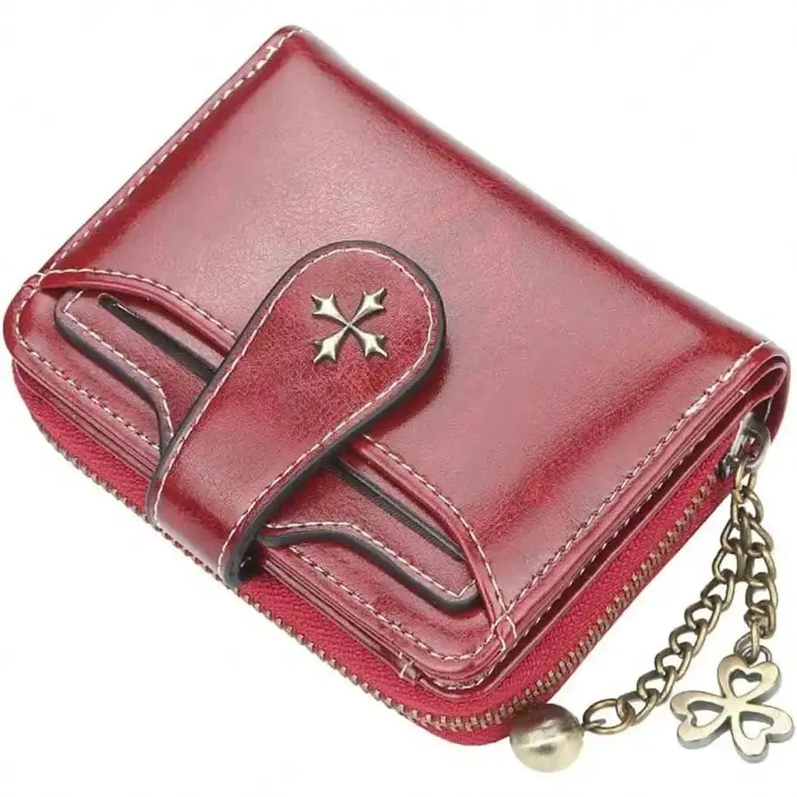 Women's retro red leather mini wallet with zip closure, double-fold design and clover charm chain.