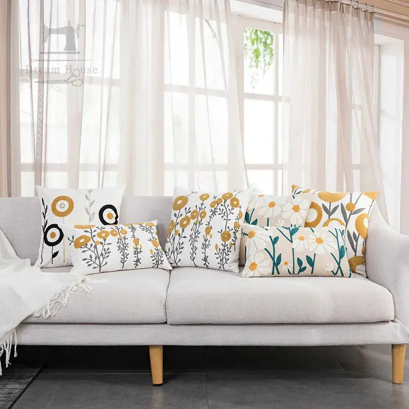 Boho floral tufted cotton cushion covers on a light sofa; six decorative pillows in yellow, gray and teal