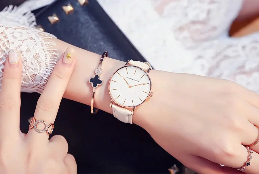 HANNAH MARTIN women's wristwatch with white dial, rose-gold case and white leather strap; two bracelets shown