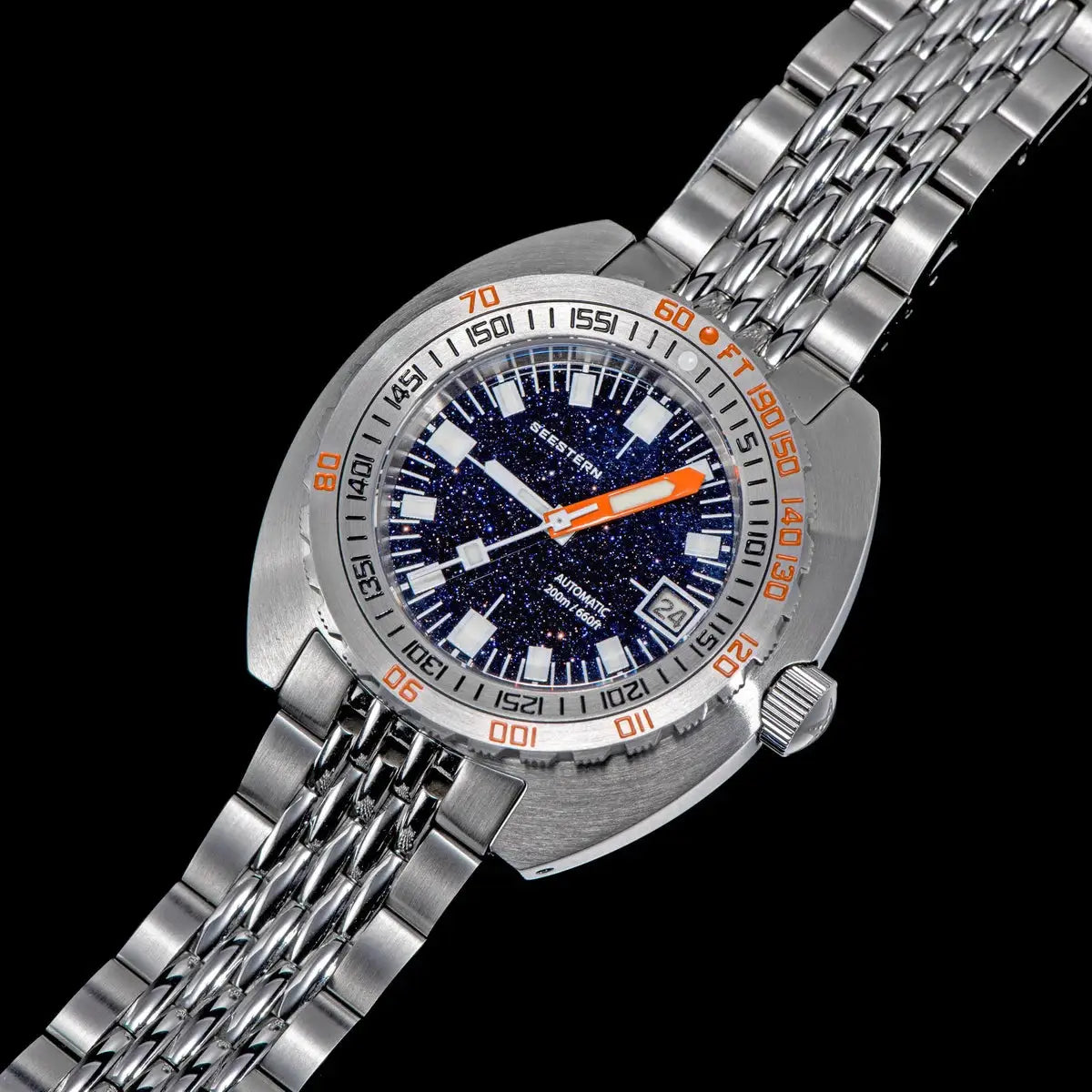 Seestern men's diver wristwatch with blue starry dial, orange hands, date window, stainless steel bracelet.