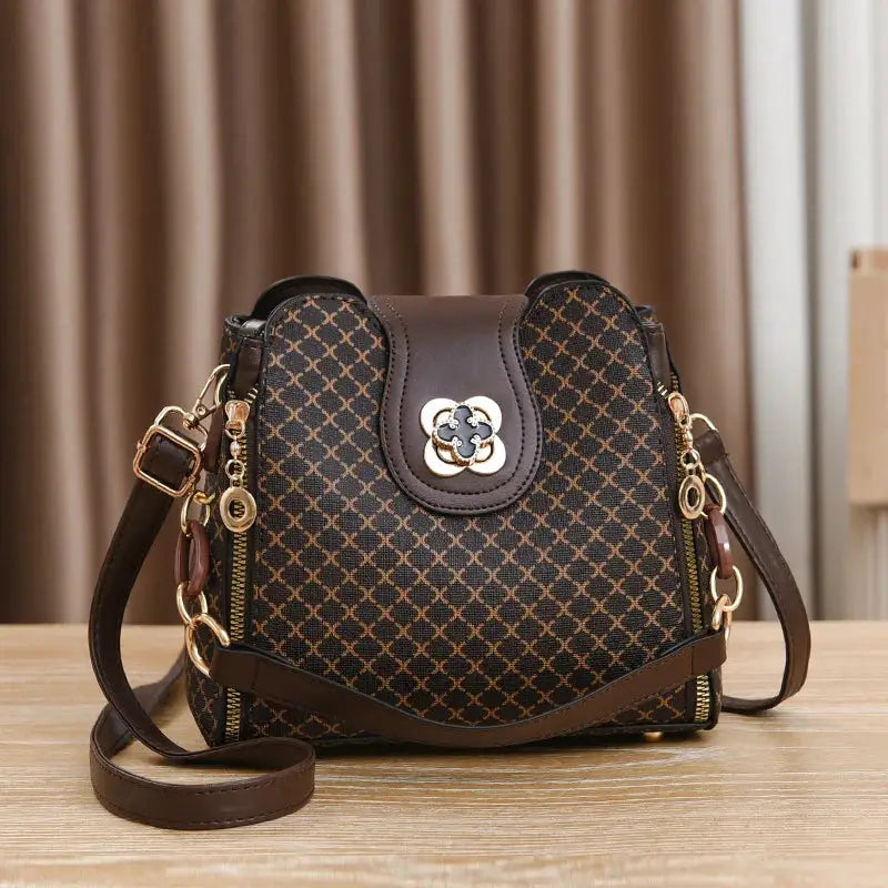 Women’s handbag bucket crossbody with flip check print, brown leather trim, gold hardware
