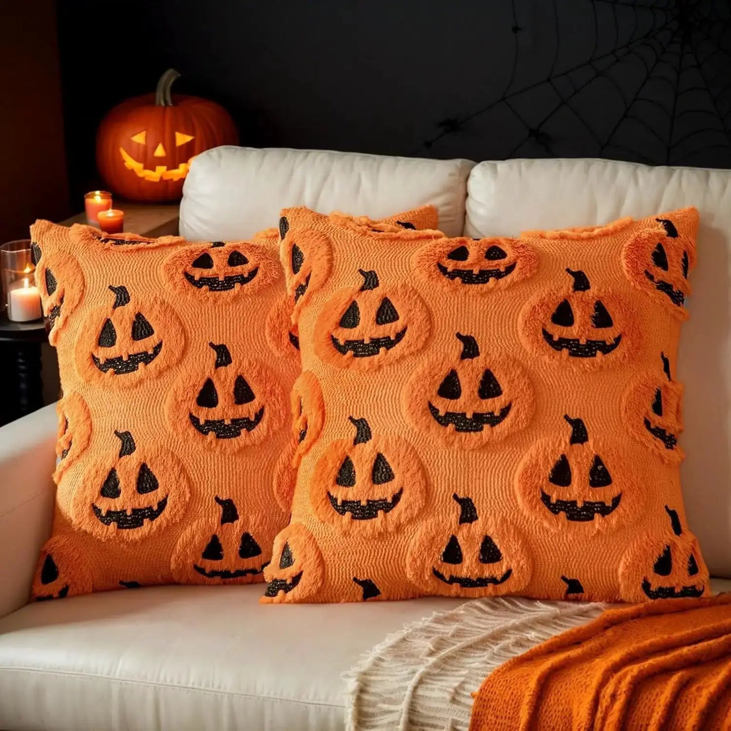 Simples Market orange jack-o-lantern throw pillows pair, faux fur texture, 18x18 inches on sofa
