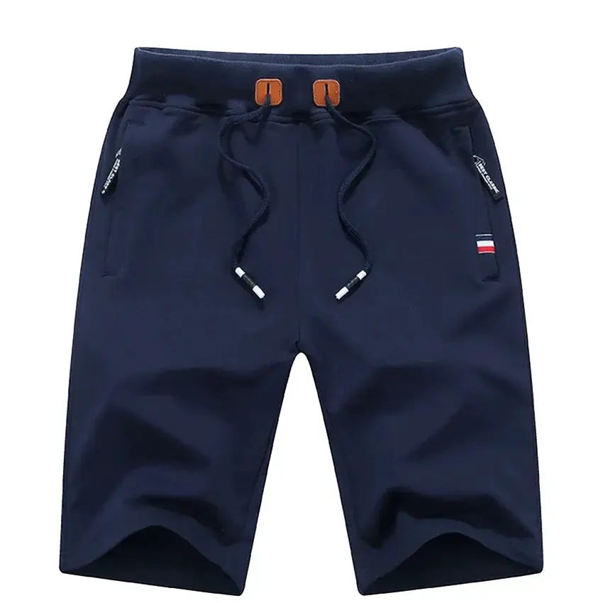 Men's 3/4 length navy shorts, quick-dry nylon with drawstring waist, orange eyelets, zip pockets, flag detail