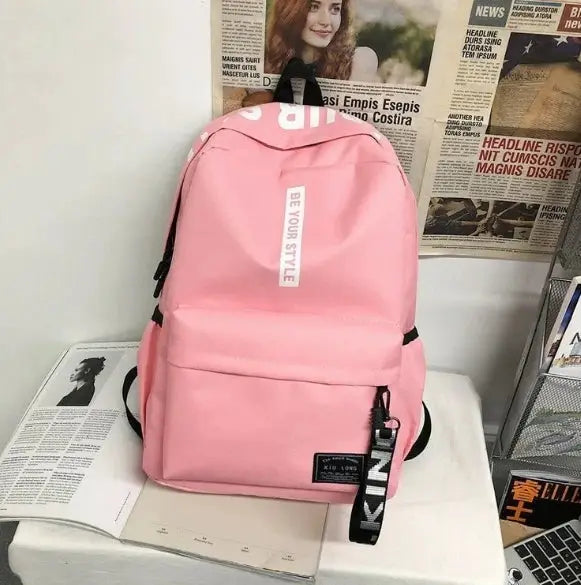 Pink backpack with front pocket, fashion trend style, large capacity for teens and adults.