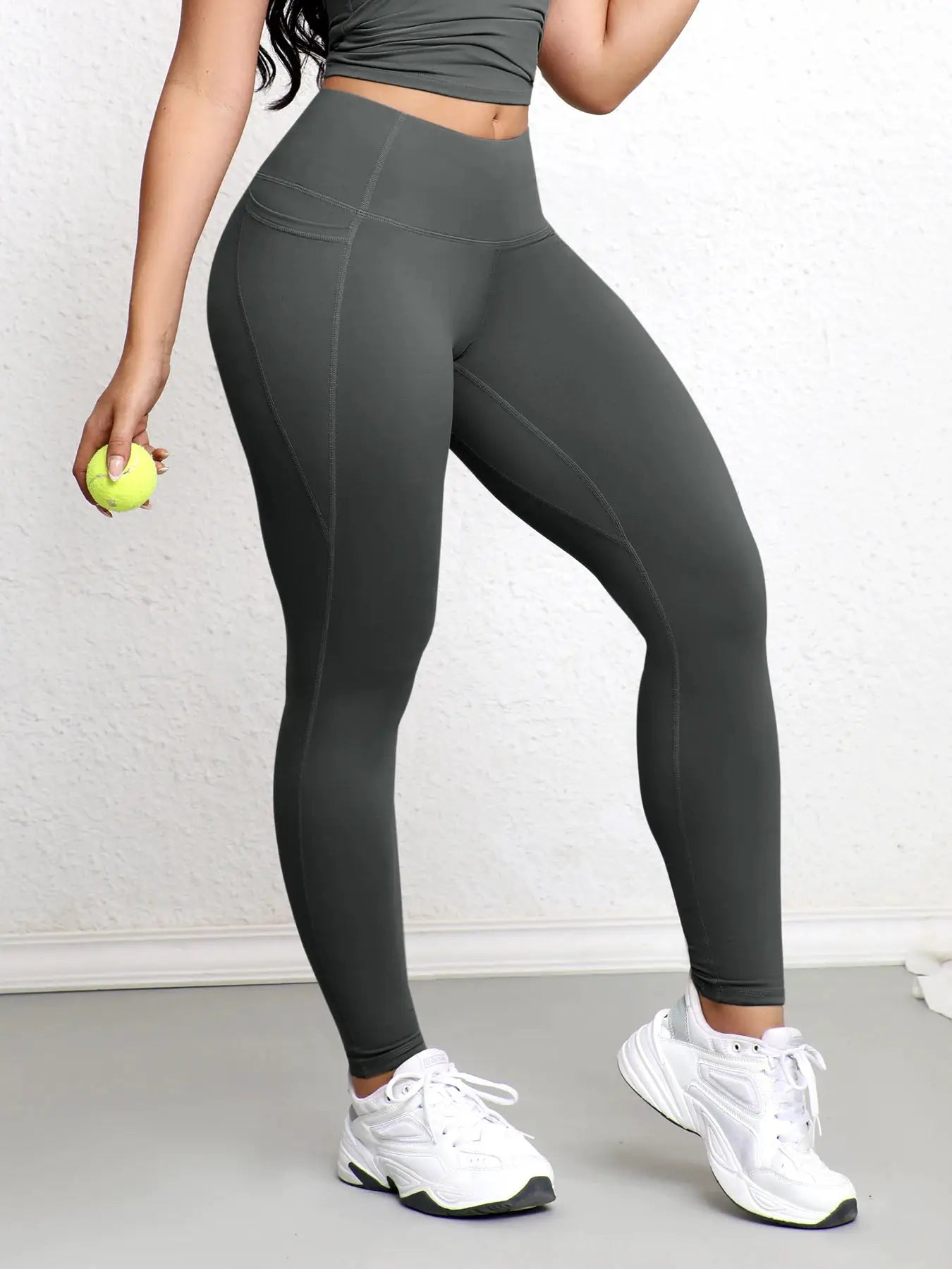 Women's high-waist leggings with pockets in dark gray, stretchy workout tights.