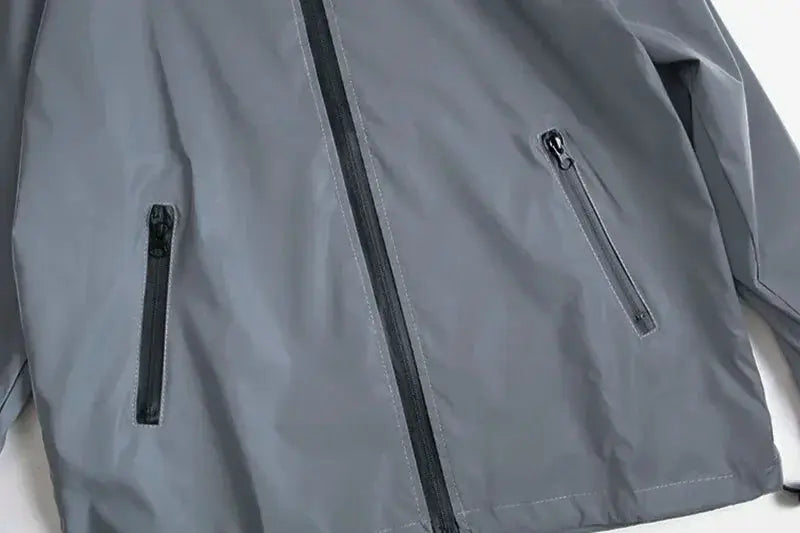 Jacket, solid gray polyester with black zippers and front pockets.