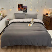 Duvet cover in dark gray on a queen-size bed with matching pillow shams