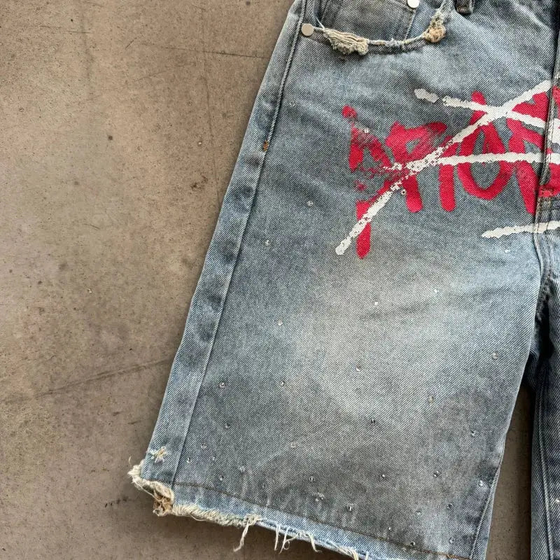 Denim jorts with rhinestone accents, distressed hem and red graffiti print, unisex