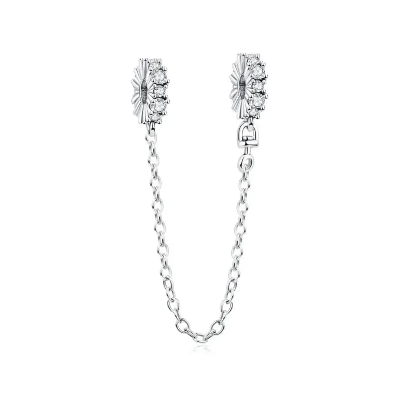 Two sterling silver bracelet charms with sun/star zircon accents, connected by a delicate chain
