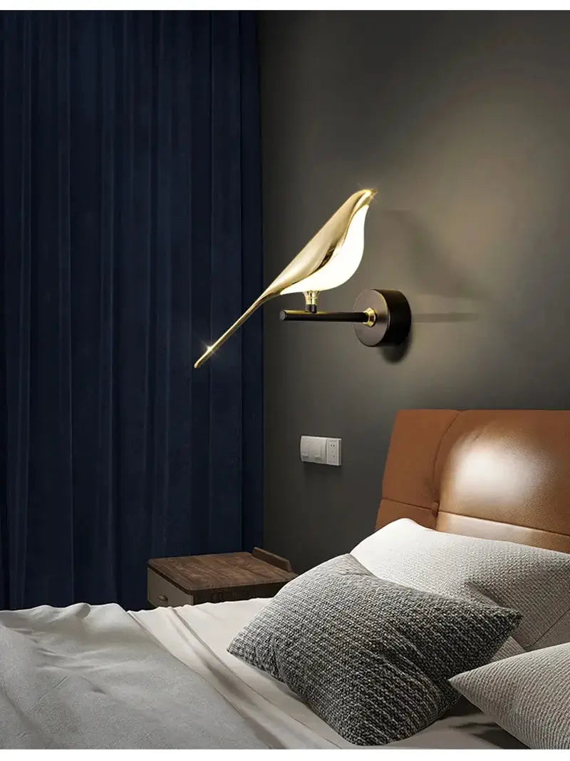 Simples Market Magpie bird LED wall lamp with gold finish on black wall mount above bed