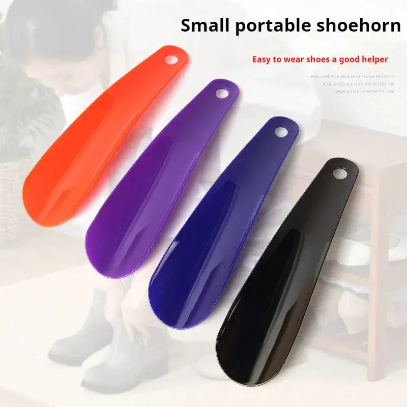 Shoe horn set of 4, 16 cm plastic short-handle shoehorns in orange, purple, blue, and black.