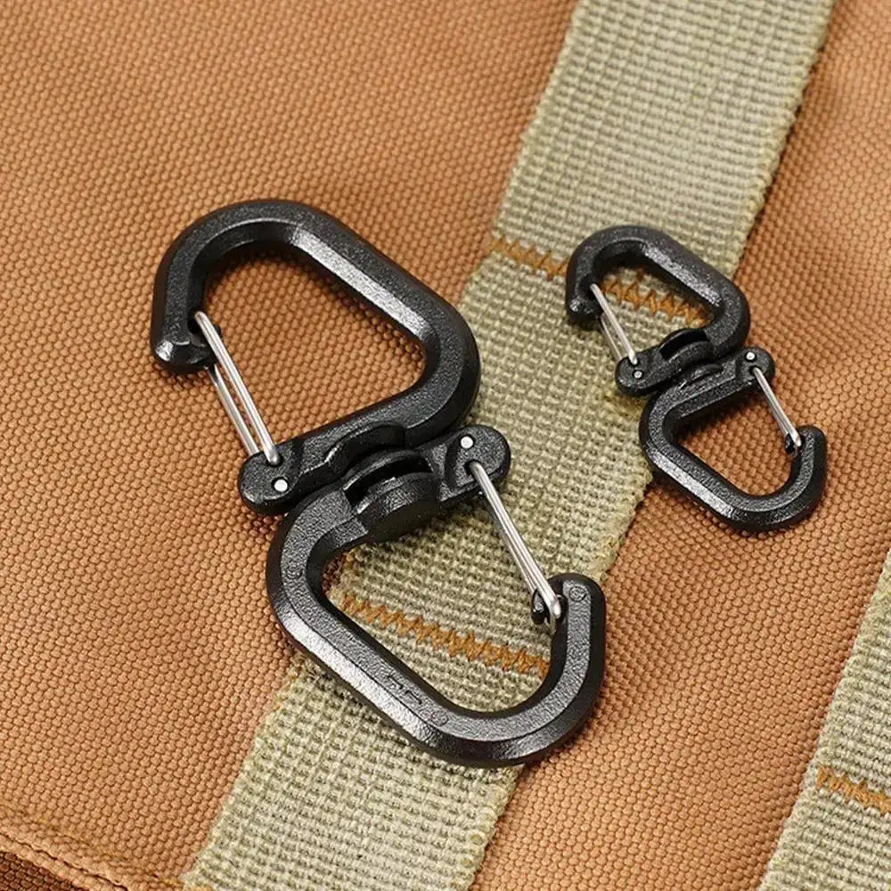 Black metal double-clip carabiner set with 360-degree swivel on tan backpack strap