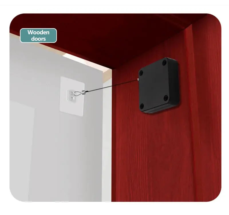 Automatic sensor door closer; black square surface door stopper mounted on a wooden door with metal linkage.