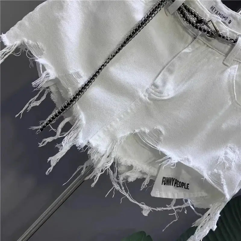White raw-hem denim mini skirt with distressed hem, pockets, and a chain belt; Funny People tag visible