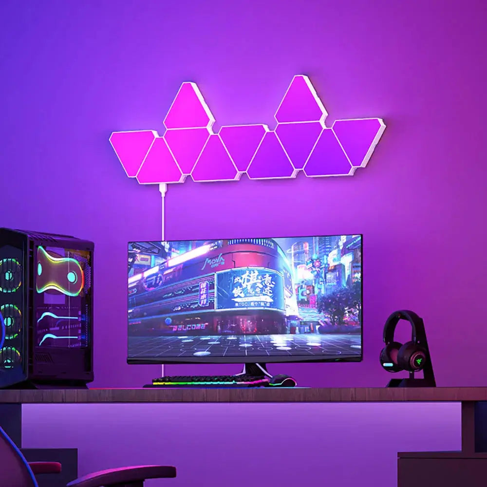 LED triangular RGB wall lamp with interconnected triangle panels and pink-purple glow above desk