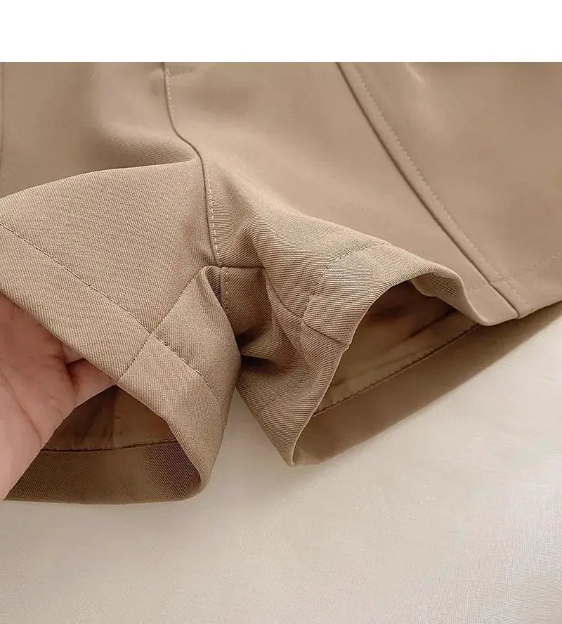 Casual beige women's shorts with cuffed hem; close-up of fabric texture