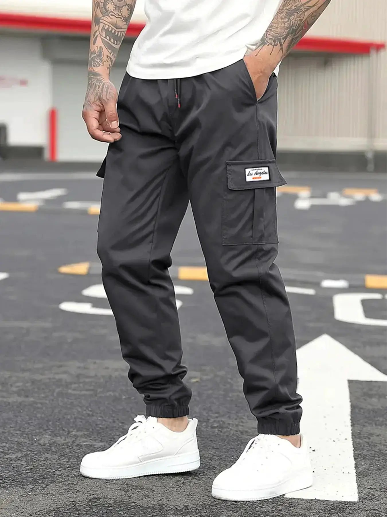Spring men's cargo jogger pants in dark gray with drawstring waist, elastic cuffs, and side cargo pocket with patch