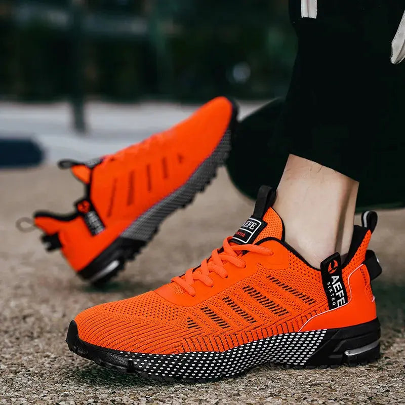 Men's running shoes by Simples Market, orange breathable knit upper with black speckled sole
