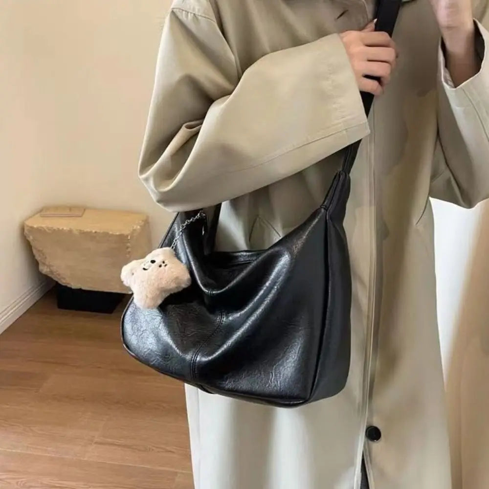 Women’s black PU leather slouchy shoulder bag with plush teddy charm, large capacity