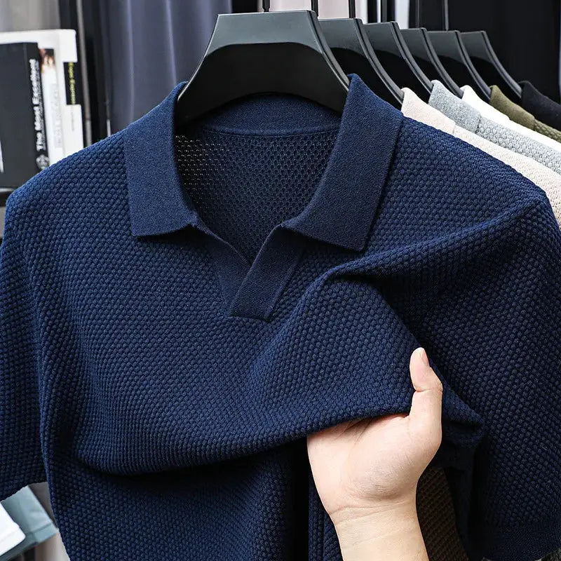 Men's navy blue 100% cotton knitted polo shirt on hanger; textured short-sleeve polo with color variants visible