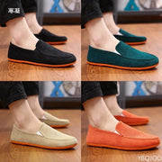 Men's fabric slip-on loafers; four color options (black, teal, beige, orange) with orange soles.