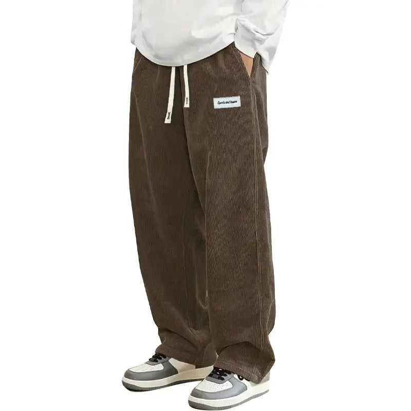 Men's brown corduroy casual pants with elastic drawstring waist, loose baggy straight fit.