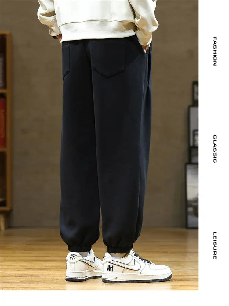 Men's black jogger sweatpants with back flap pockets and elastic cuffs