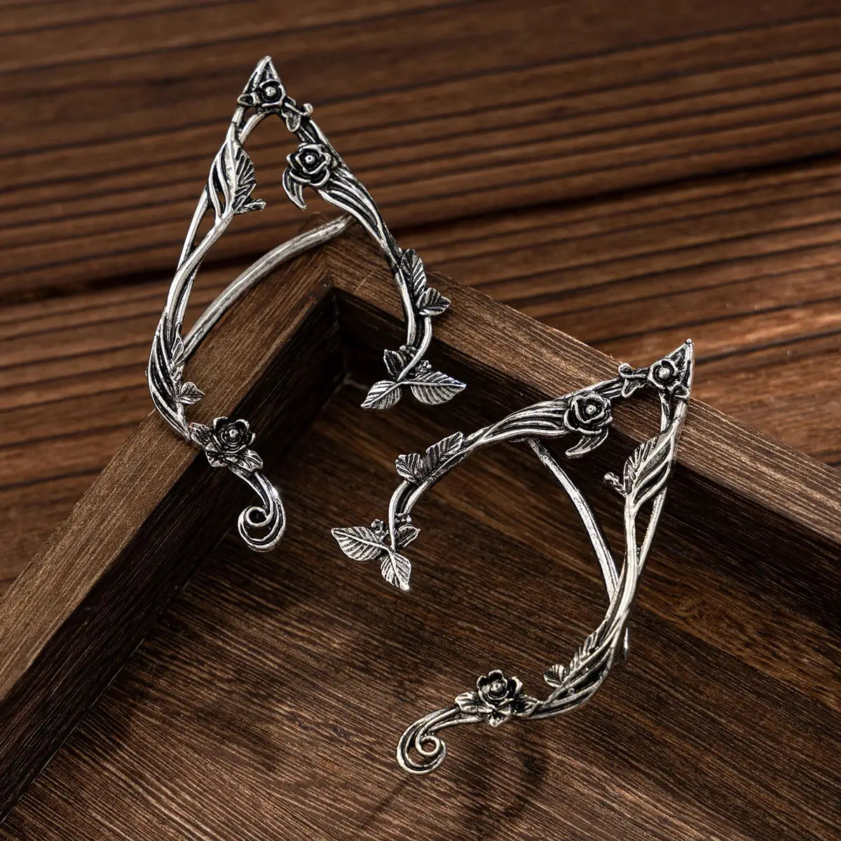 Pair of elf flower leaf ear clips with vine and rose details in silver-tone metal
